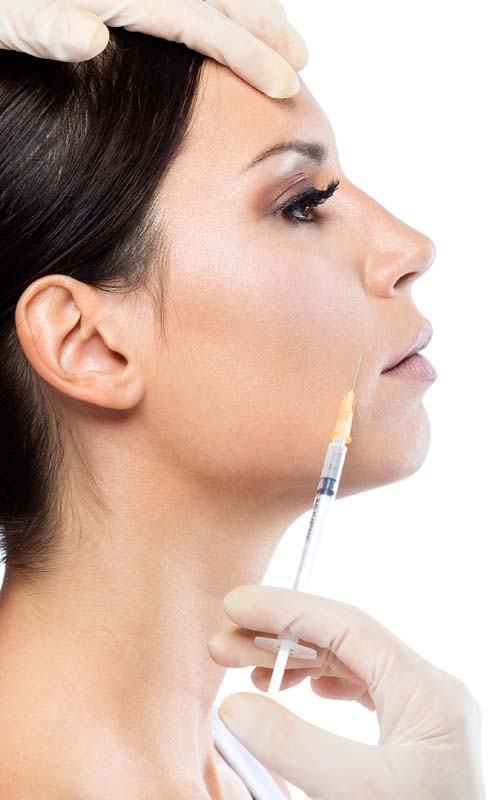 Portrait of beautiful young woman getting botox cosmetic injection in her face over white background.